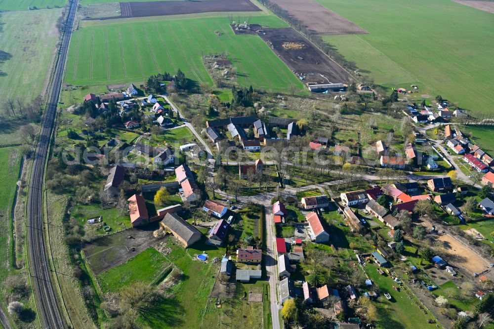 Buberow from the bird's eye view: Agricultural land and field boundaries surround the settlement area of the village in Buberow in the state Brandenburg, Germany