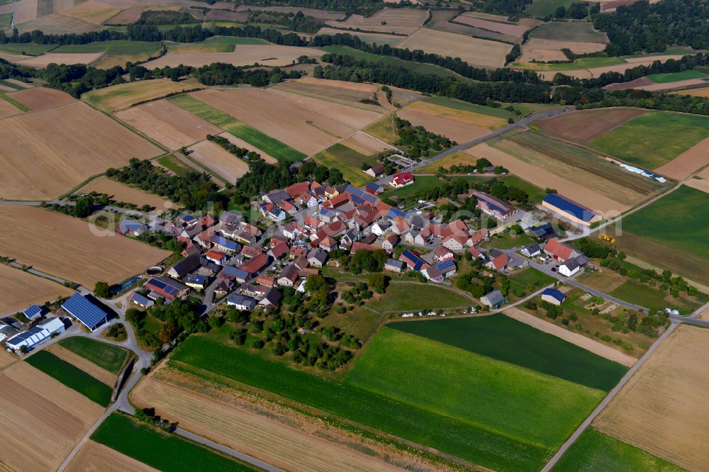 Buch from above - Agricultural land and field boundaries surround the settlement area of the village in Buch in the state Bavaria, Germany