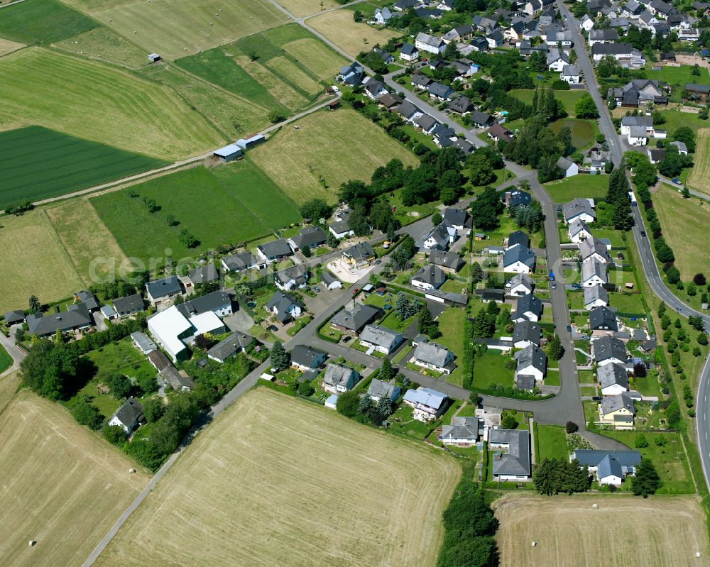 Buch from above - Agricultural land and field boundaries surround the settlement area of the village in Buch in the state Rhineland-Palatinate, Germany