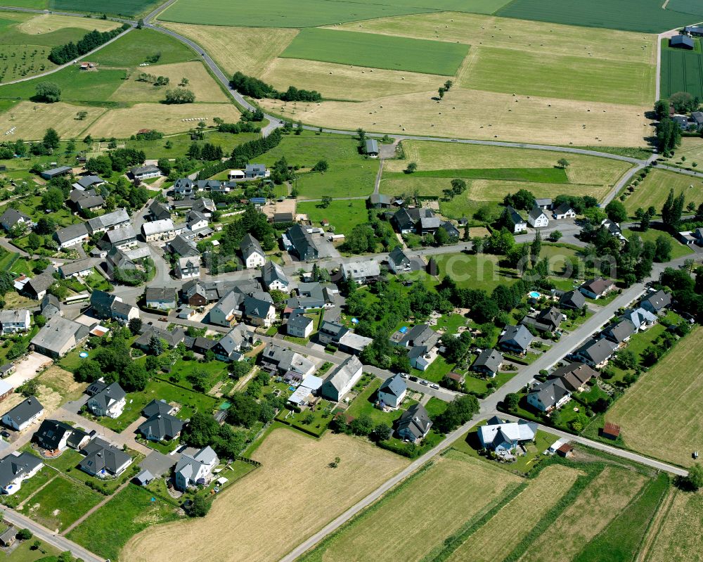 Buch from the bird's eye view: Agricultural land and field boundaries surround the settlement area of the village in Buch in the state Rhineland-Palatinate, Germany