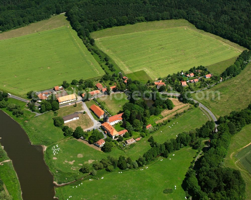 Bursfelde from the bird's eye view: Agricultural land and field boundaries surround the settlement area of the village in Bursfelde in the state Lower Saxony, Germany