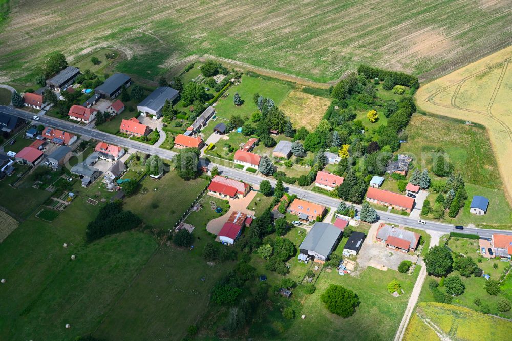 Carlsruhe from the bird's eye view: Agricultural land and field boundaries surround the settlement area of the village in Carlsruhe in the state Mecklenburg - Western Pomerania, Germany