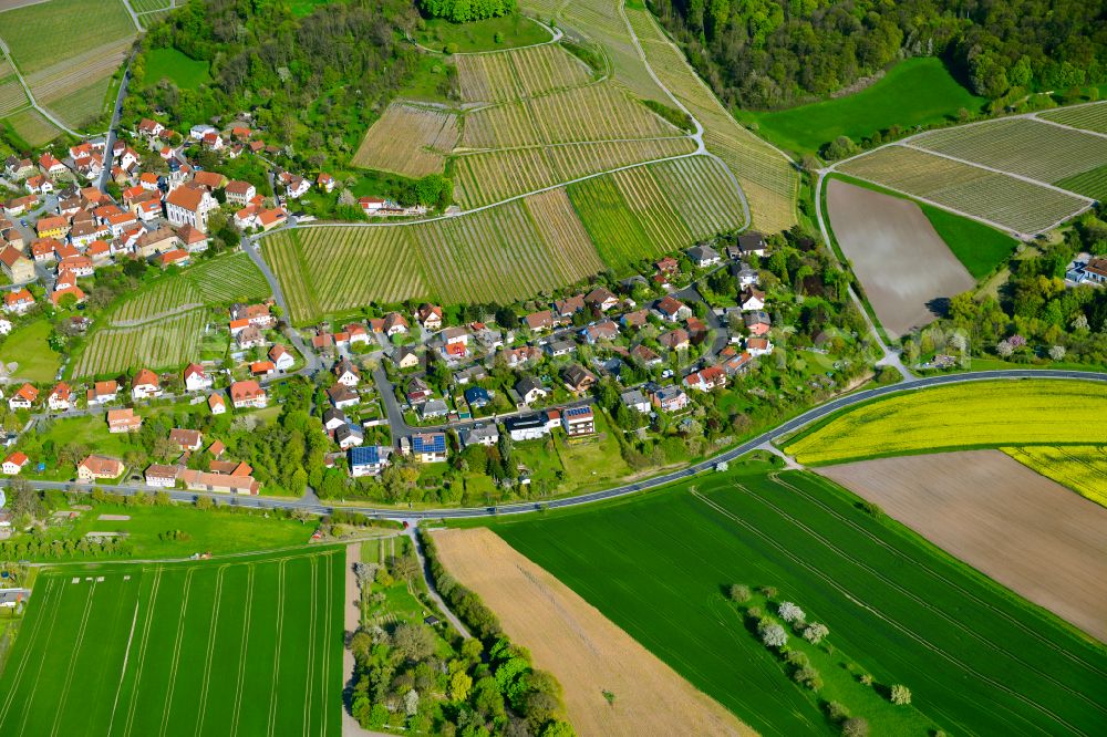 Castell from above - Agricultural land and field boundaries surround the settlement area of the village in Castell in the state Bavaria, Germany