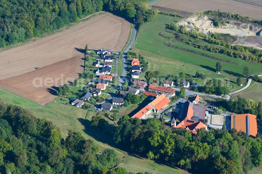 Clus from above - Agricultural land and field boundaries surround the settlement area of the village in Clus in the state Lower Saxony, Germany