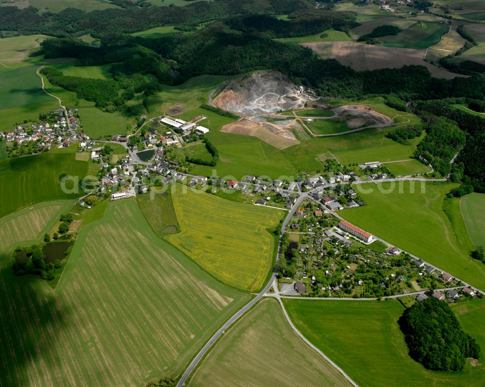 Cossengrün from above - Agricultural land and field boundaries surround the settlement area of the village in Cossengrün in the state Thuringia, Germany