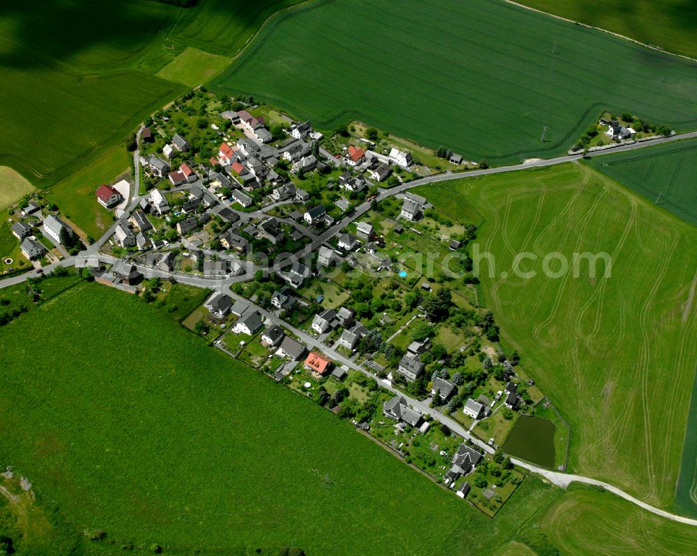 Cossengrün from the bird's eye view: Agricultural land and field boundaries surround the settlement area of the village in Cossengrün in the state Thuringia, Germany