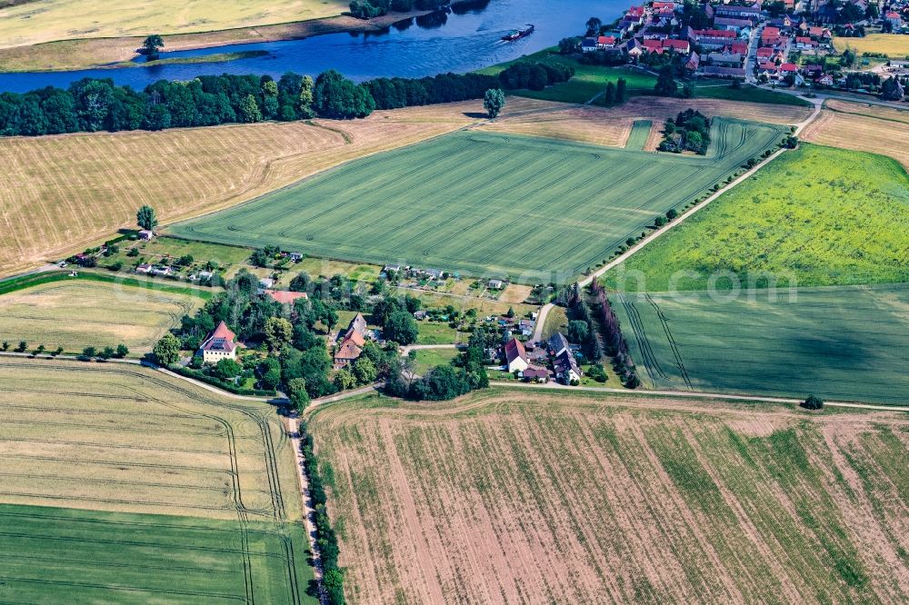 Cottewitz from the bird's eye view: Agricultural land and field boundaries surround the settlement area of the village in Cottewitz in the state Saxony, Germany