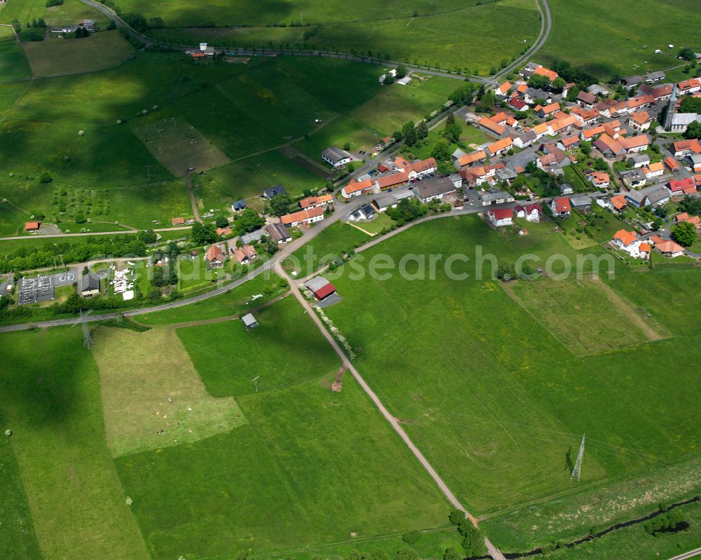 Crainfeld from the bird's eye view: Agricultural land and field boundaries surround the settlement area of the village in Crainfeld in the state Hesse, Germany