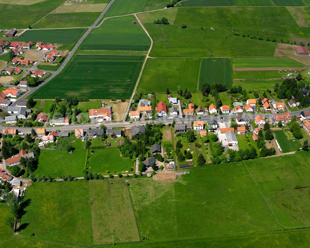 Aerial image Crainfeld - Agricultural land and field boundaries surround the settlement area of the village in Crainfeld in the state Hesse, Germany