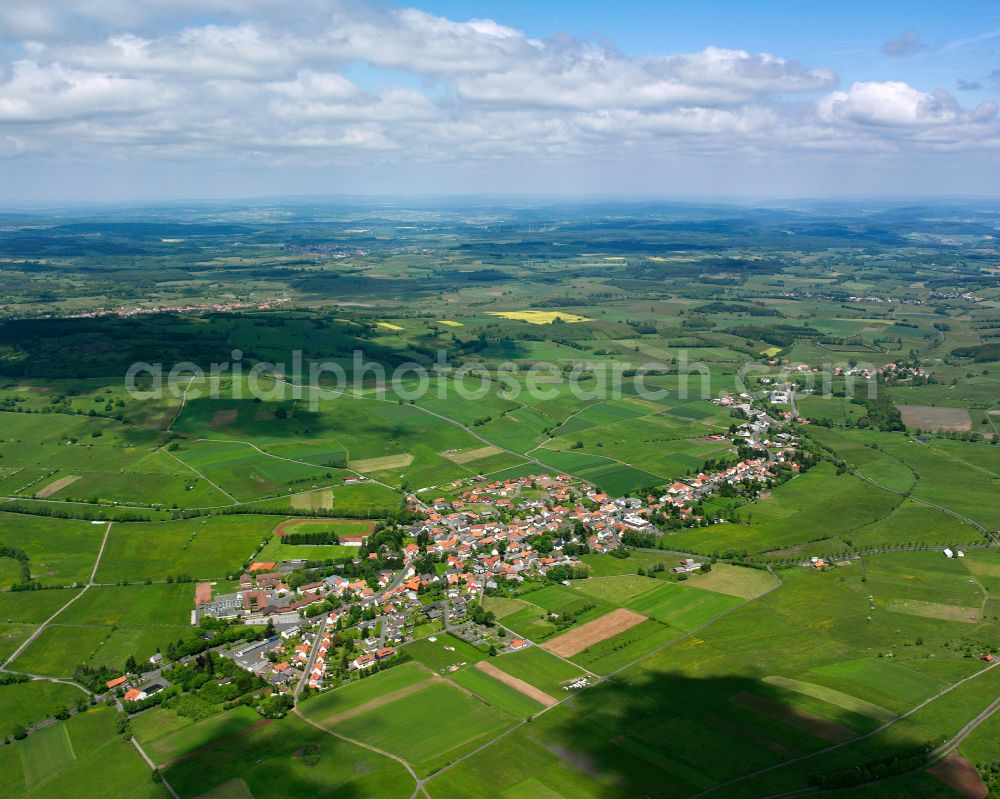 Aerial image Crainfeld - Agricultural land and field boundaries surround the settlement area of the village in Crainfeld in the state Hesse, Germany