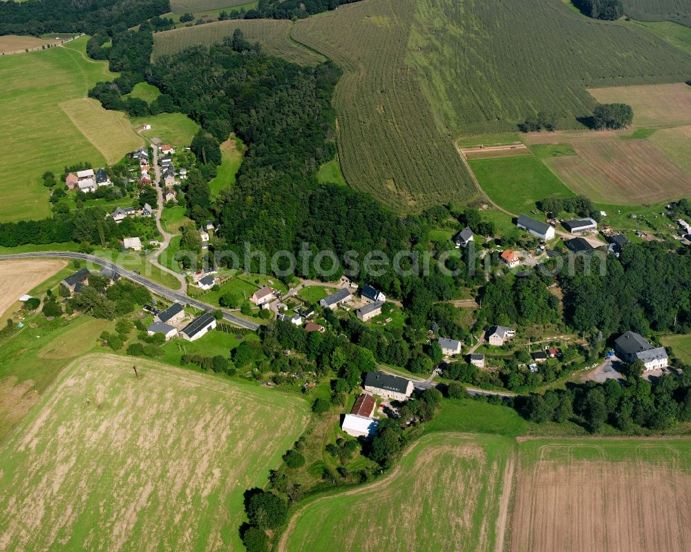 Aerial image Cunnersdorf - Agricultural land and field boundaries surround the settlement area of the village in Cunnersdorf in the state Saxony, Germany