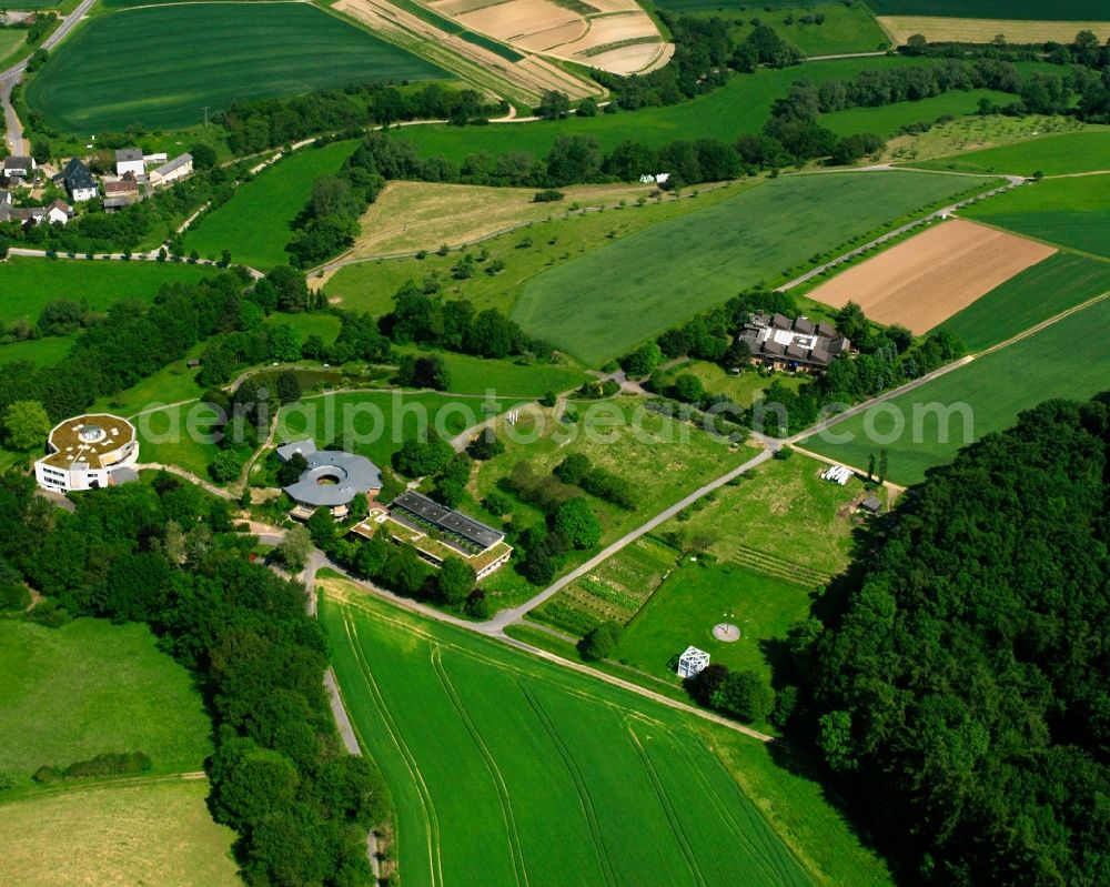 Dauborn from the bird's eye view: Agricultural land and field boundaries surround the settlement area of the village in Dauborn in the state Hesse, Germany