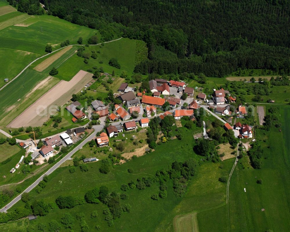 Dauernberg from above - Agricultural land and field boundaries surround the settlement area of the village in Dauernberg in the state Baden-Wuerttemberg, Germany