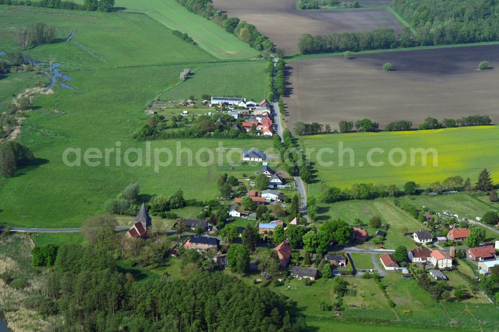 Döbbersen from the bird's eye view: Agricultural land and field boundaries surround the settlement area of the village in Döbbersen in the state Mecklenburg - Western Pomerania, Germany