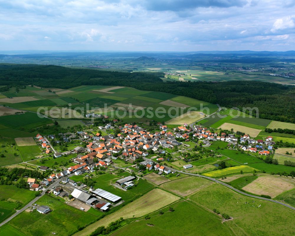 Aerial image Deckenbach - Agricultural land and field boundaries surround the settlement area of the village in Deckenbach in the state Hesse, Germany