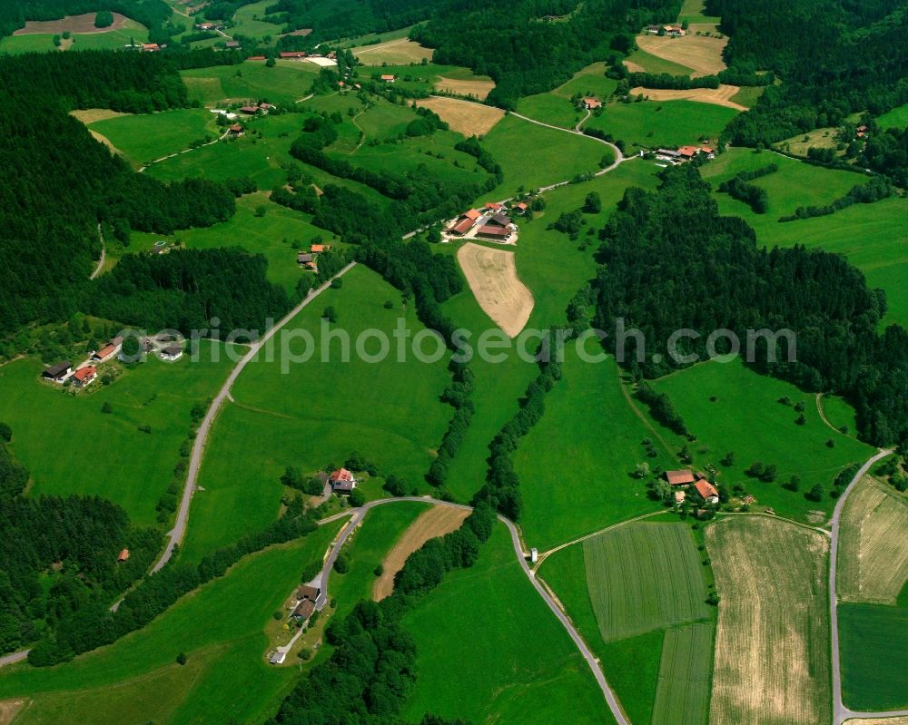 Degenberg from above - Agricultural land and field boundaries surround the settlement area of the village in Degenberg in the state Bavaria, Germany