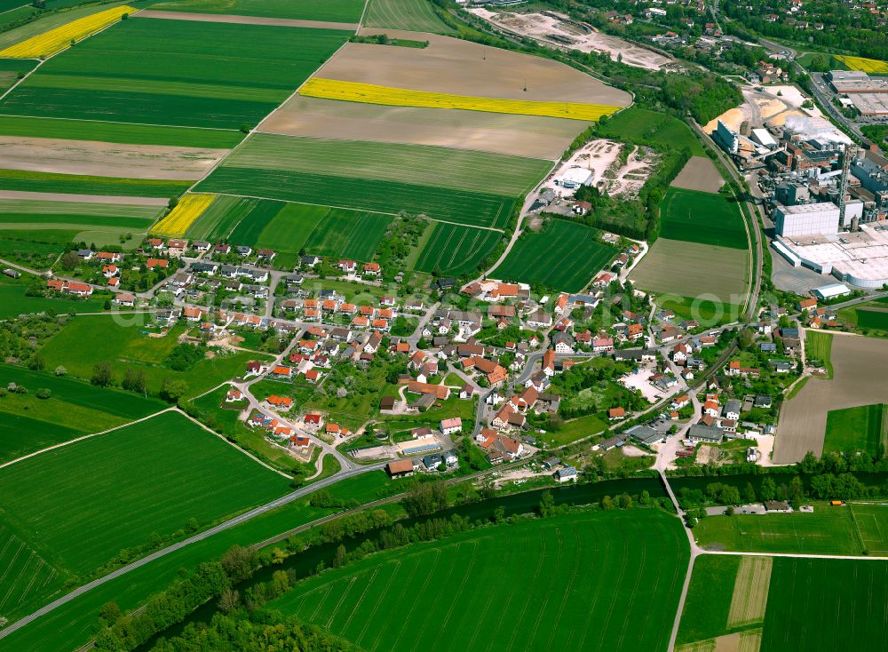 Dettingen from the bird's eye view: Agricultural land and field boundaries surround the settlement area of the village in Dettingen in the state Baden-Wuerttemberg, Germany