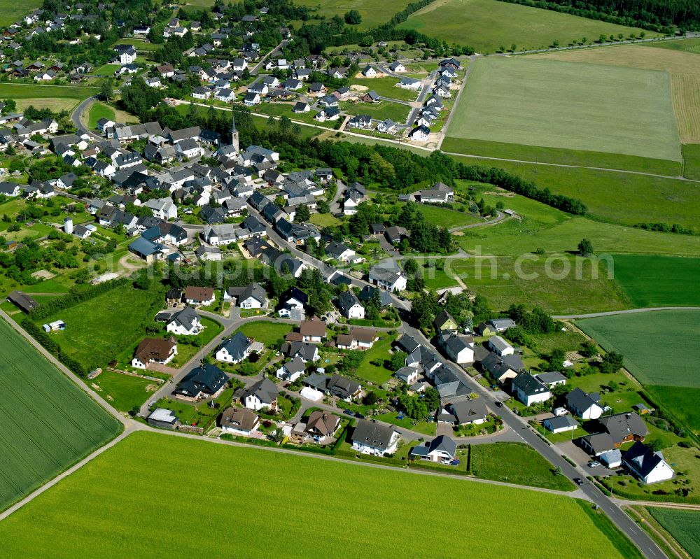 Dichtelbach from above - Agricultural land and field boundaries surround the settlement area of the village in Dichtelbach in the state Rhineland-Palatinate, Germany