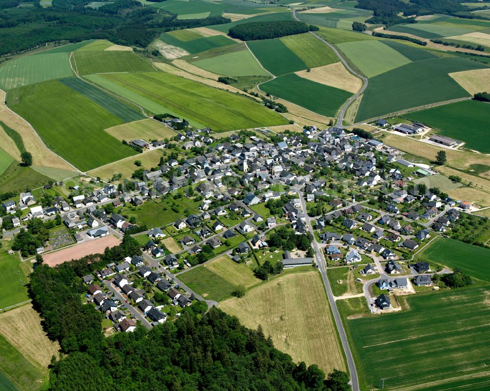 Dickenschied from above - Agricultural land and field boundaries surround the settlement area of the village in Dickenschied in the state Rhineland-Palatinate, Germany