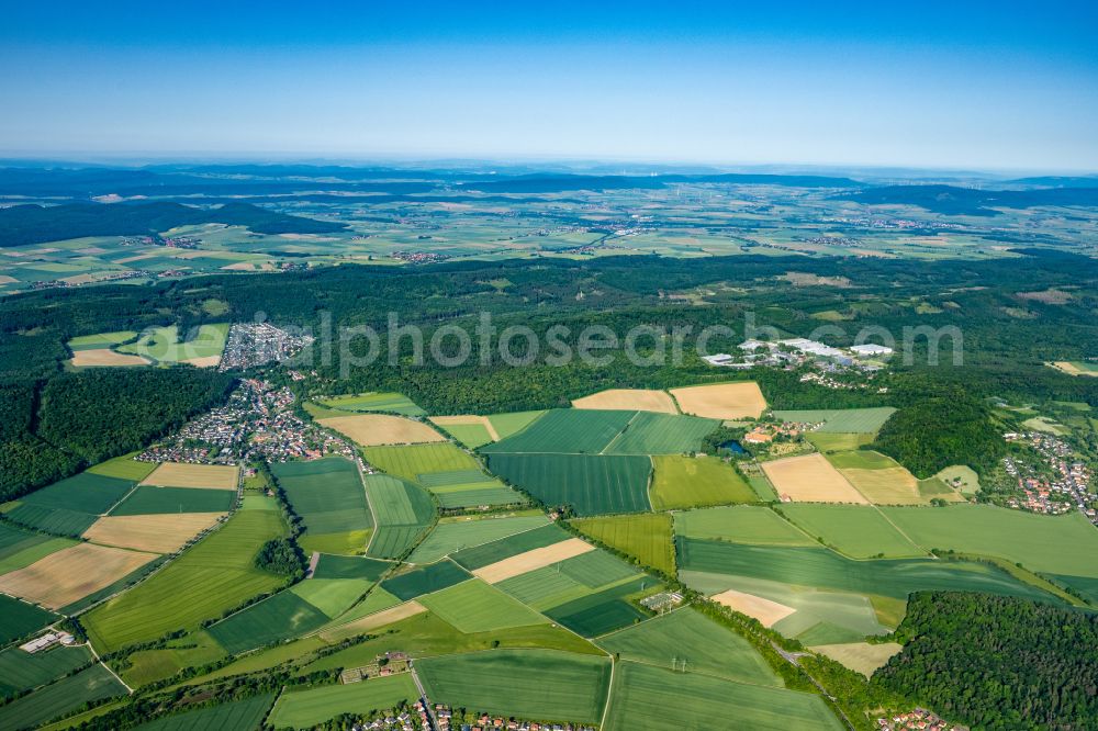 Diekholzen from above - Agricultural land and field boundaries surround the settlement area of the village on street Ostlandstrasse in Diekholzen in the state Lower Saxony, Germany