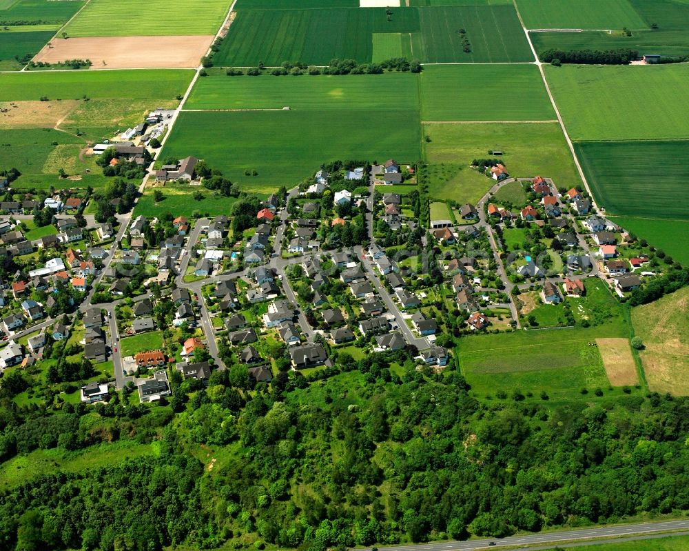 Aerial photograph Dietkirchen - Agricultural land and field boundaries surround the settlement area of the village in Dietkirchen in the state Hesse, Germany