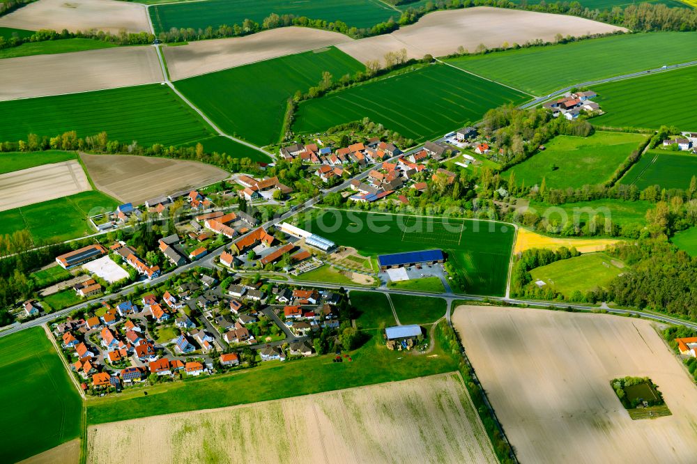 Aerial image Düllstadt - Agricultural land and field boundaries surround the settlement area of the village in Düllstadt in the state Bavaria, Germany