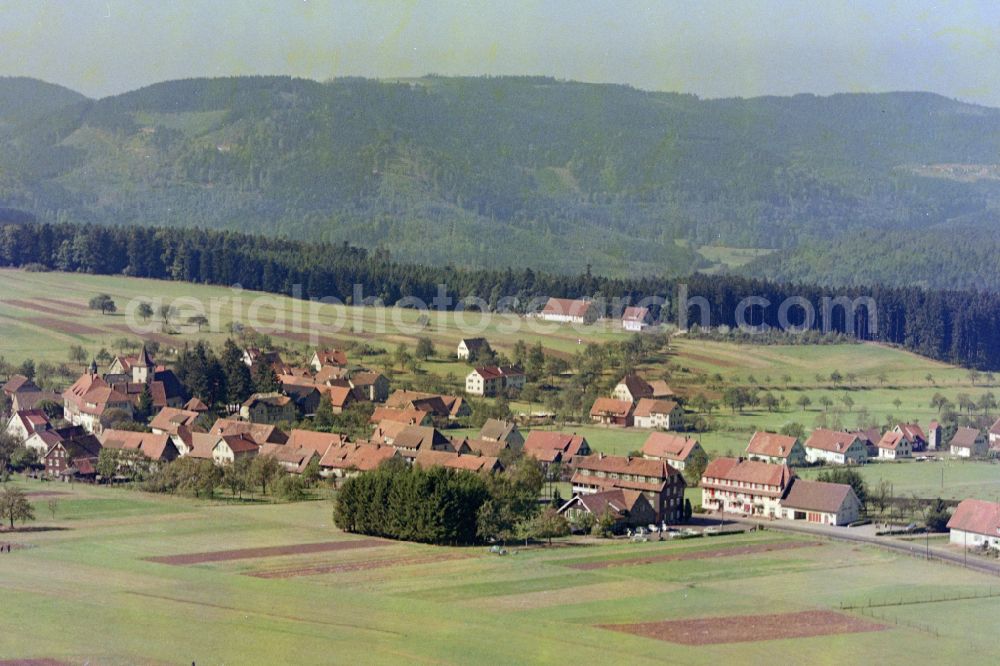 Dobel from above - Agricultural land and field boundaries surround the settlement area of the village on street Obere Bergstrasse in Dobel in the state Baden-Wuerttemberg, Germany