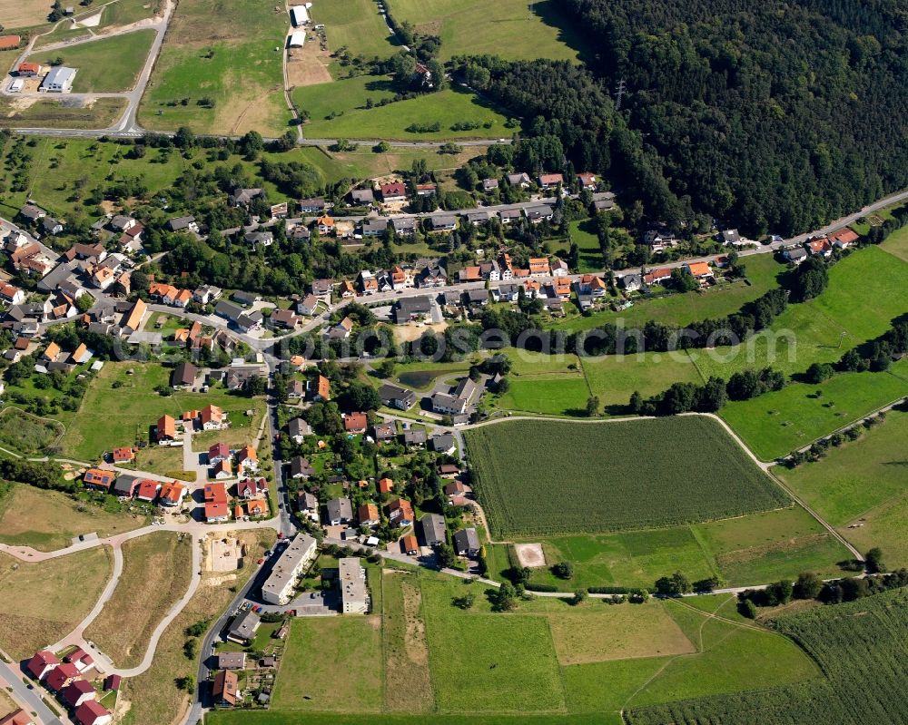 Dorf-Erbach from above - Agricultural land and field boundaries surround the settlement area of the village in Dorf-Erbach in the state Hesse, Germany