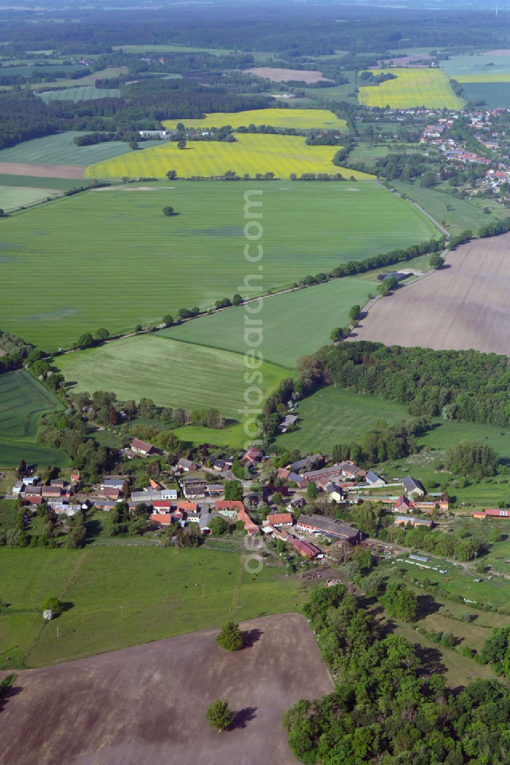 Drenkow from above - Agricultural land and field boundaries surround the settlement area of the village in Drenkow in the state Mecklenburg - Western Pomerania, Germany