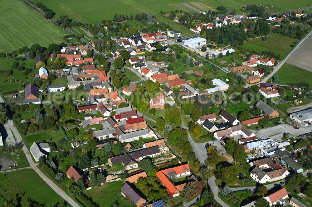 Drößig from above - Agricultural land and field boundaries surround the settlement area of the village in Droessig in the state Brandenburg, Germany