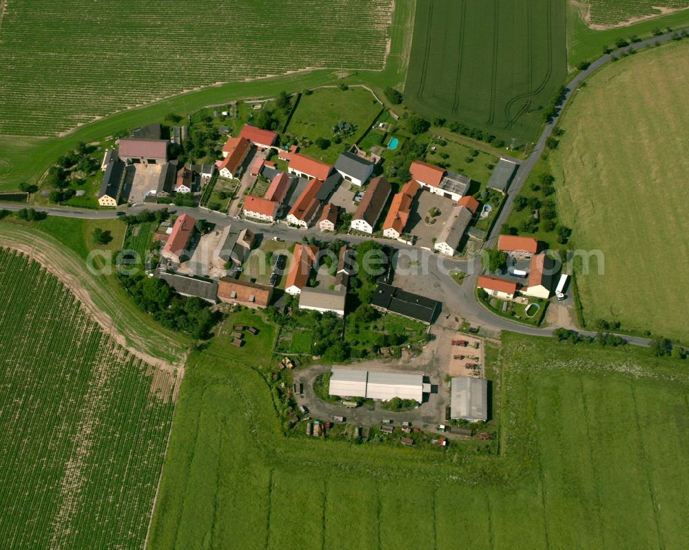 Aerial photograph Döschütz - Agricultural land and field boundaries surround the settlement area of the village in Döschütz in the state Saxony, Germany