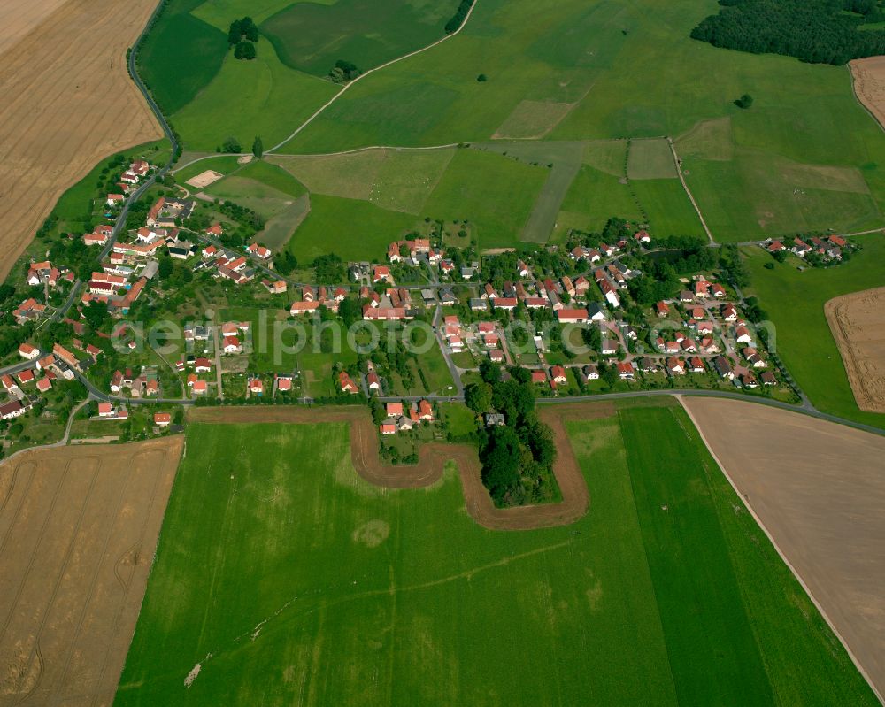 Ebersbach from above - Agricultural land and field boundaries surround the settlement area of the village in Ebersbach in the state Saxony, Germany