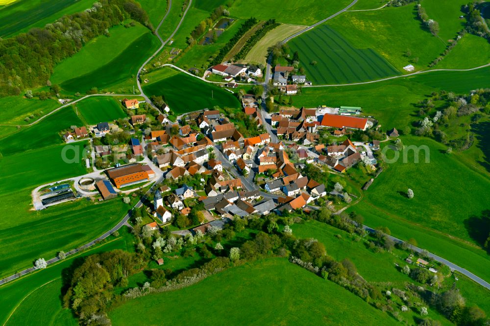 Ebersbrunn from the bird's eye view: Agricultural land and field boundaries surround the settlement area of the village in Ebersbrunn in the state Bavaria, Germany