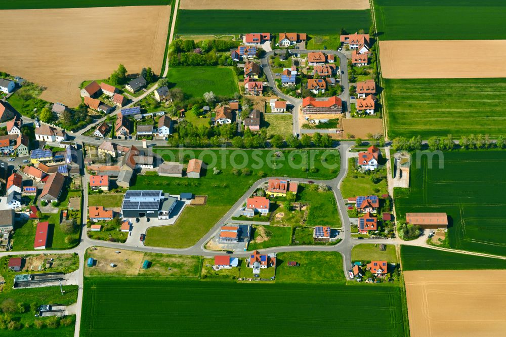 Effeldorf from above - Agricultural land and field boundaries surround the settlement area of the village in Effeldorf in the state Bavaria, Germany