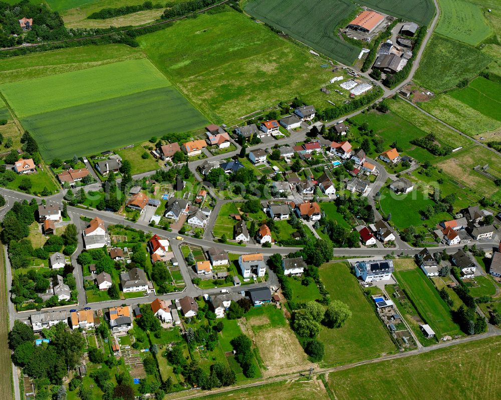 Aerial image Ehringshausen - Agricultural land and field boundaries surround the settlement area of the village in Ehringshausen in the state Hesse, Germany