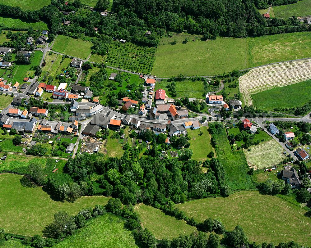 Aerial image Ehringshausen - Agricultural land and field boundaries surround the settlement area of the village in Ehringshausen in the state Hesse, Germany