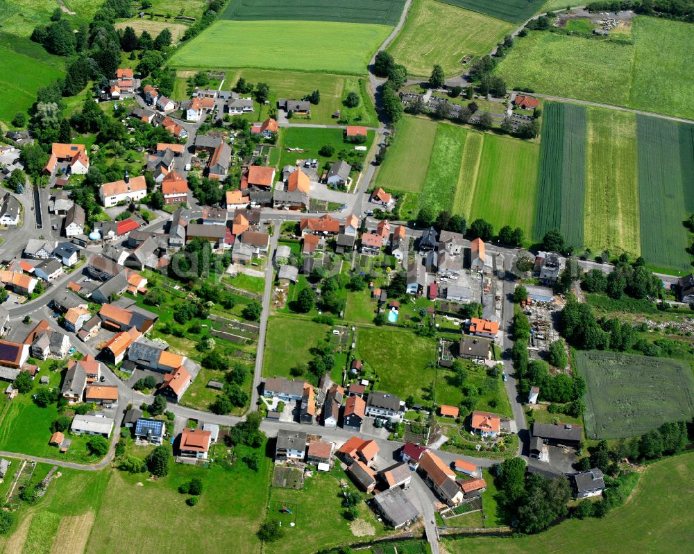 Ehringshausen from above - Agricultural land and field boundaries surround the settlement area of the village in Ehringshausen in the state Hesse, Germany