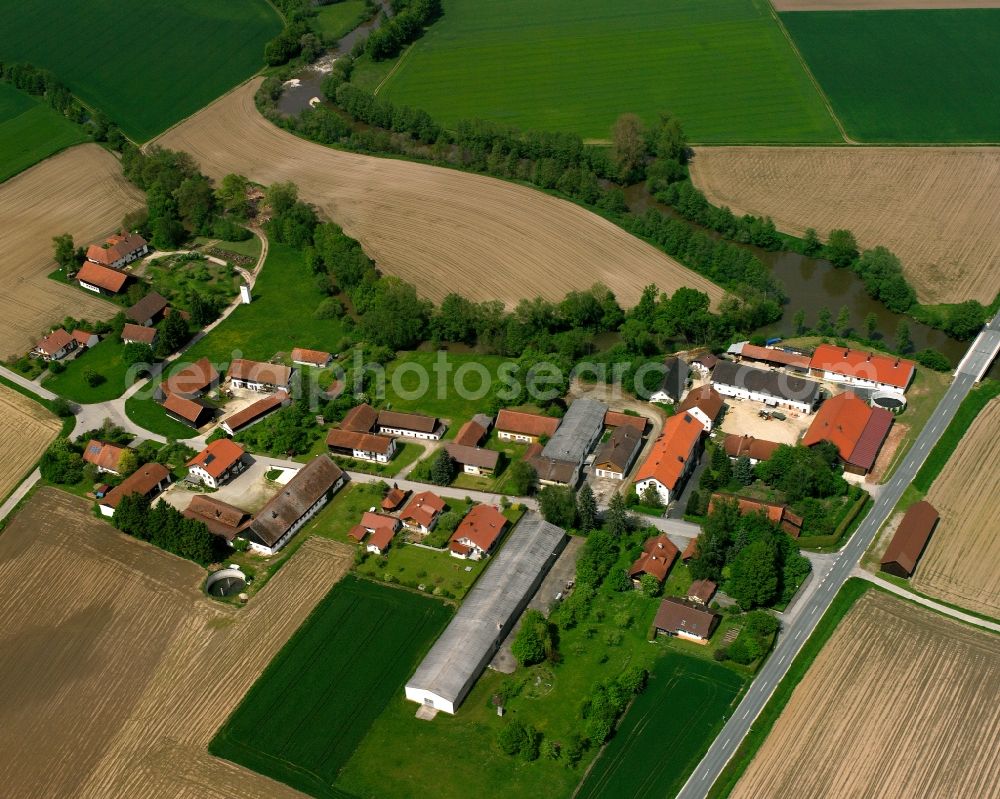 Ehrnstorf from above - Agricultural land and field boundaries surround the settlement area of the village in Ehrnstorf in the state Bavaria, Germany