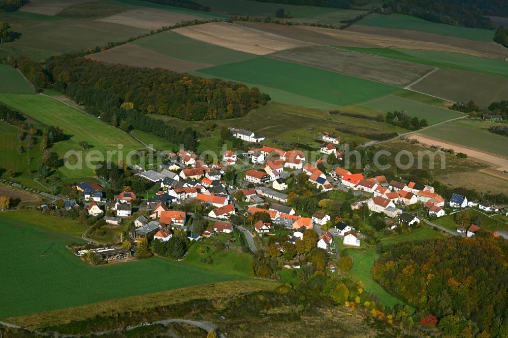 Ehweiler from above - Agricultural land and field boundaries surround the settlement area of the village in Ehweiler in the state Rhineland-Palatinate, Germany