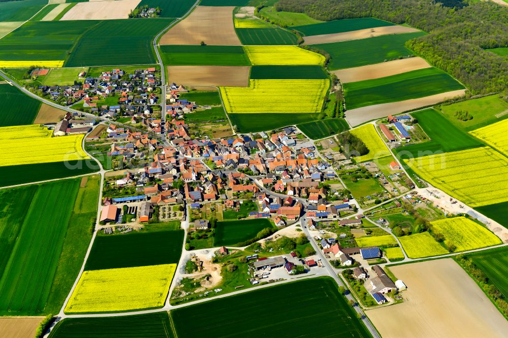 Eichfeld from the bird's eye view: Agricultural land and field boundaries surround the settlement area of the village in Eichfeld in the state Bavaria, Germany