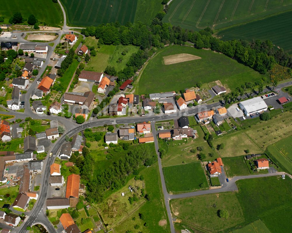 Eifa from above - Agricultural land and field boundaries surround the settlement area of the village in Eifa in the state Hesse, Germany