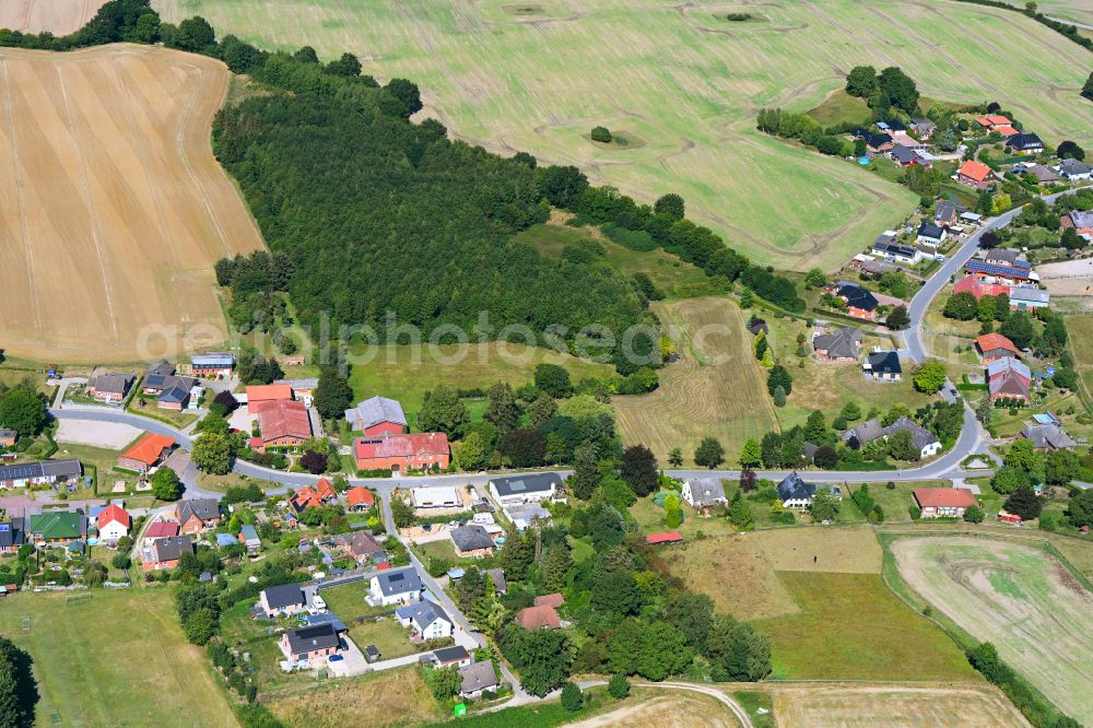 Eilsdorf from above - Agricultural land and field boundaries surround the settlement area of the village in Eilsdorf in the state Schleswig-Holstein, Germany