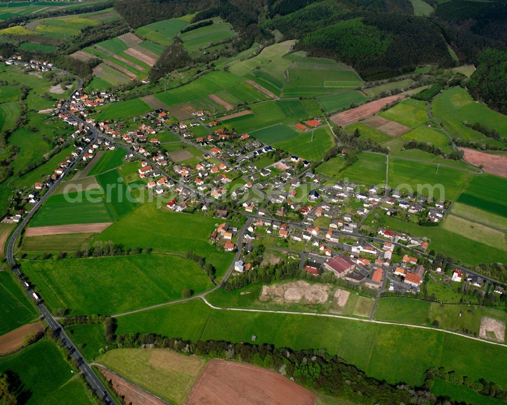 Eitra from the bird's eye view: Agricultural land and field boundaries surround the settlement area of the village in Eitra in the state Hesse, Germany