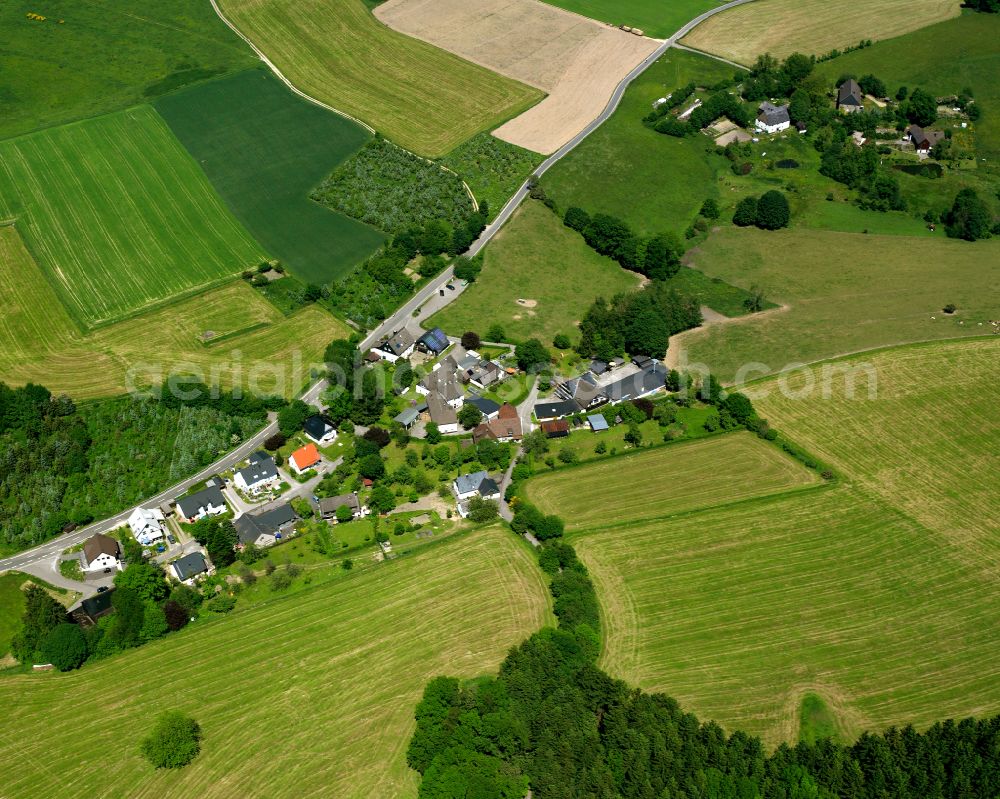 Elbringhausen from above - Agricultural land and field boundaries surround the settlement area of the village in Elbringhausen in the state North Rhine-Westphalia, Germany