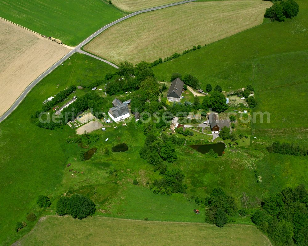 Elbringhausen from the bird's eye view: Agricultural land and field boundaries surround the settlement area of the village in Elbringhausen in the state North Rhine-Westphalia, Germany