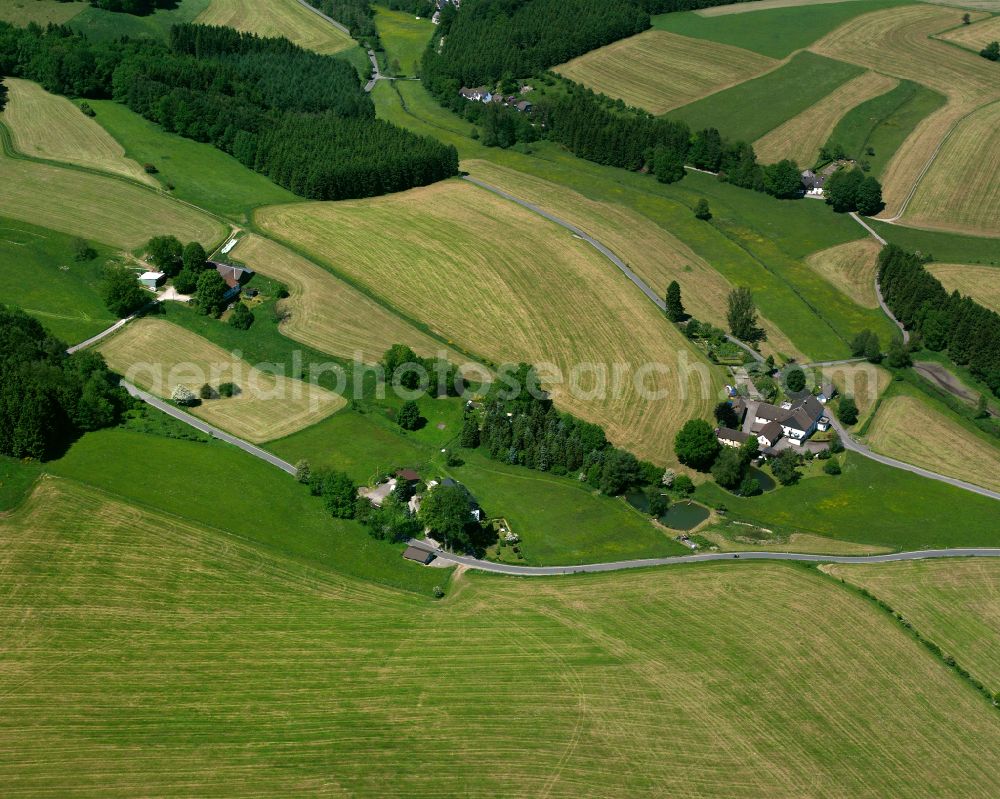 Aerial image Elbringhausen - Agricultural land and field boundaries surround the settlement area of the village in Elbringhausen in the state North Rhine-Westphalia, Germany