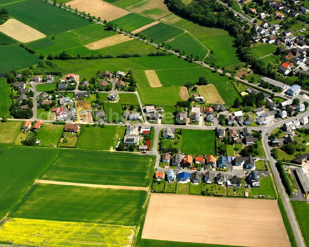 Aerial photograph Ellar - Agricultural land and field boundaries surround the settlement area of the village in Ellar in the state Hesse, Germany