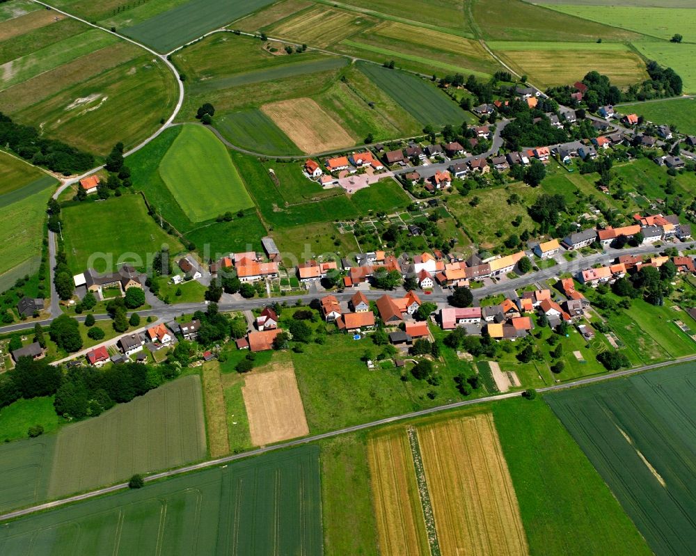 Ellershausen bei Münden from the bird's eye view: Agricultural land and field boundaries surround the settlement area of the village in Ellershausen bei Münden in the state Lower Saxony, Germany