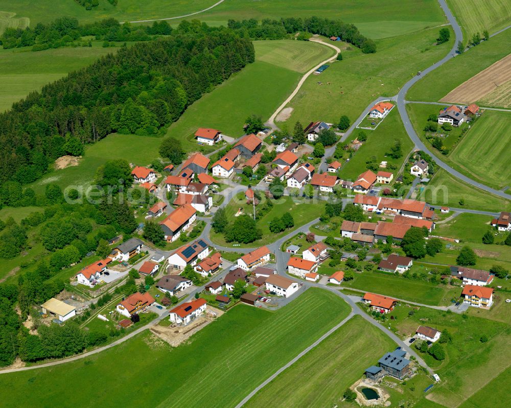 Elmberg from above - Agricultural land and field boundaries surround the settlement area of the village in Elmberg in the state Bavaria, Germany