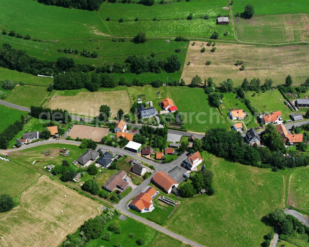 Aerial image Elpenrod - Agricultural land and field boundaries surround the settlement area of the village in Elpenrod in the state Hesse, Germany